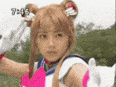 a woman in a sailor moon costume is giving a peace sign