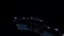 a group of people standing in a dark room
