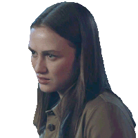 a woman with long hair and a brown jacket is looking at the camera