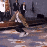 a man in a green jacket is running on a carpet