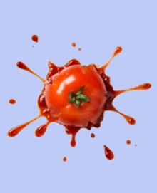 a tomato with ketchup splashing out of it