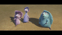 three cartoon hedgehogs are standing next to each other on a sandy surface