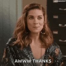 a woman in a sequined jacket is making a funny face and saying awww thanks .
