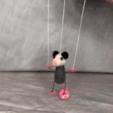 a puppet of an opossum is being held by a person