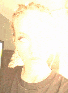 a close up of a woman 's face with the letter n visible in the corner