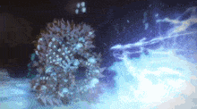 a close up of a christmas wreath with a blue light coming out of it .