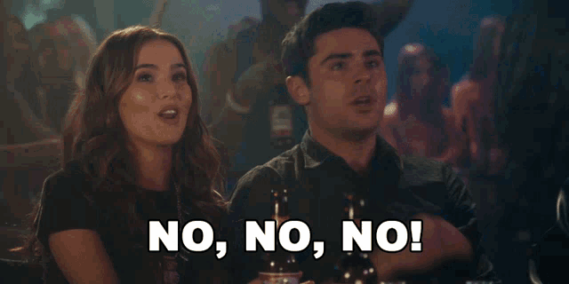 a man and a woman are sitting at a table and the woman says no