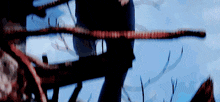 a blurry picture of a person holding a rope with a blue sky in the background