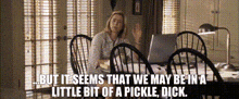 a woman sits at a table with a laptop and says but it seems that we may be