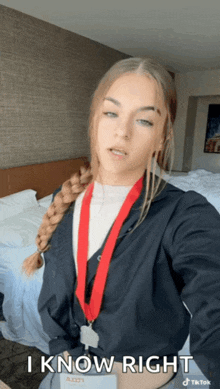 a woman with a medal around her neck is taking a selfie with the caption " iknow right "