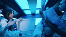 a woman in a bikini is reading a book in a blue room