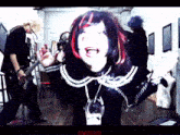 a group of people are standing in a room and one of them is wearing a necklace that says ' puptice ' on it
