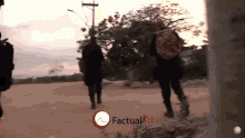 two soldiers are walking down a dirt road with a red circle that says factual rj