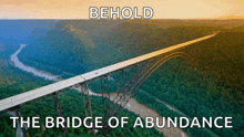 a bridge over a river with the words behold the bridge of abundance underneath it