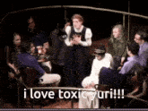 a group of people sitting around a table with the words i love toxic yuri written on the bottom