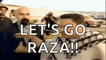 a man is talking into a microphone while another man says let 's go raza