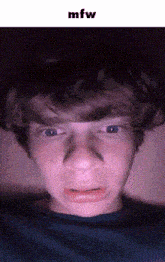 a close up of a young man 's face with the words mfw below it