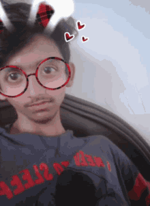 a boy wearing glasses and a shirt that says ' keep on '