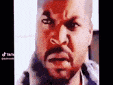 a man with a beard and mustache is making a funny face .
