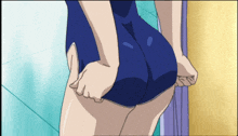a girl in a blue swimsuit is standing in front of a door