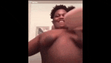 a shirtless man is making a funny face while taking a selfie .