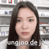 a close up of a woman 's face with the name seungjoo de juli written below her