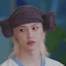 a close up of a person wearing a hat with ears on it .