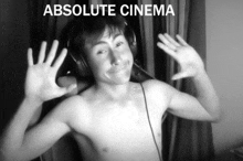 a shirtless man wearing headphones with the words " absolute cinema " on the bottom
