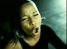 a close up of a woman with her mouth open .