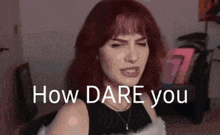 a woman with red hair is making a funny face with the words `` how dare you '' .
