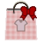 a pink shopping bag with a white shirt and a red bow on it .