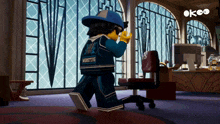 a lego man wearing a monsters shirt is standing in an office