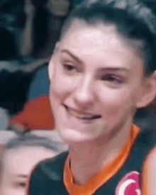 a close up of a woman 's face with a smile on her face