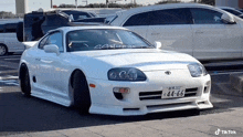 a white car has a license plate that says 44-66