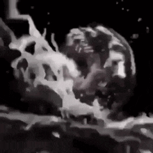 a black and white painting of a person 's face splashing in a pool of water .