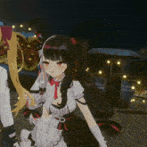 a girl with long black hair is standing next to another girl with blonde hair