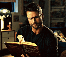 a man is reading a book called goldilocks and three bears