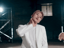 a man in a white jacket holds his neck in pain