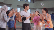 a man in a white shirt is surrounded by a group of people