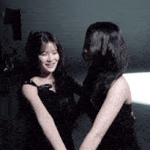 two women are hugging each other and smiling for the camera