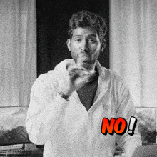 a man wearing a white hoodie with the word no written on it