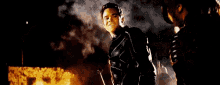 a man is holding a gun that is shooting smoke .