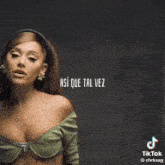 ariana grande is wearing a green top and a headband while singing .