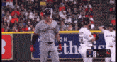 a baseball player wearing a cleveland jersey stands in front of a crowd