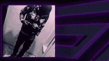 a man in a camo jacket is standing in front of a purple background