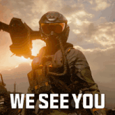 a soldier in a gas mask stands in front of a sign that says " we see you "