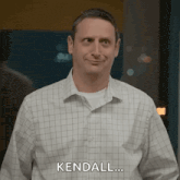 a man in a plaid shirt is smiling and saying `` kendall ... '' .