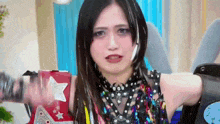 a woman in a colorful costume with a star on her arm