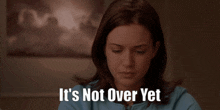 a woman says it 's not over yet while looking down