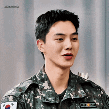 a man in a military uniform has a name tag that says " jangmykoon "